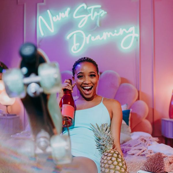 Woman feeling energetic and full of life in a bright, sunlit room.